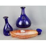 Three pieces of Kastrup-Holmegaard cobalt blue glass and a carnival glass model of a boat.