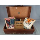 A vintage suitcase containing a large quantity of vintage sheet music and similar.