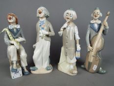 Four Spanish porcelain figurines of clowns by Casades, largest approximately 29 cm (h).