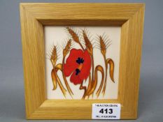 Moorcroft Pottery - a framed plaque decorated in the Harvest Poppy pattern,