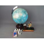 An illuminated globe, quantity of thimbles and cast iron money bank.