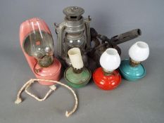 A small collection of oil lamps and similar.