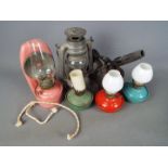A small collection of oil lamps and similar.