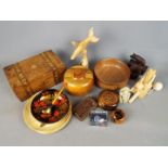 A collection of treen items and a small Chinese carved stone Buddha.