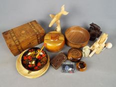 A collection of treen items and a small Chinese carved stone Buddha.