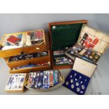 A large quantity of souvenir collector spoons and storage chest of drawers.