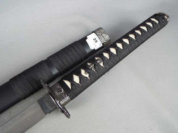 A reproduction Japanese sword with dragon decorated tsuba, - Image 4 of 5