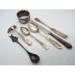 A collection of silver and white metal items to include hallmarked napkin ring,