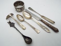 A collection of silver and white metal items to include hallmarked napkin ring,