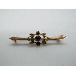 9ct gold - a 9ct gold bar brooch with stone set centre,