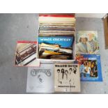 A collection of 12" and 7" vinyl records to include The Beatles, Wings, John Lennon, The Carpenters,