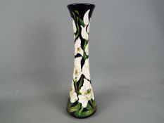 Moorcroft Pottery - a tall vase of waisted form decorated in the Buckingham Orchid,