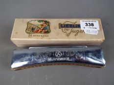 An M Spranger curved octave harmonica 'C', contained in original box.