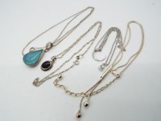 Four silver necklaces.