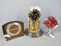 A Kundo anniversary clock, a Westclox Big Ben repeater alarm clock and one other.