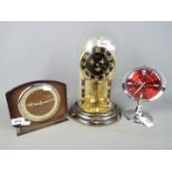 A Kundo anniversary clock, a Westclox Big Ben repeater alarm clock and one other.