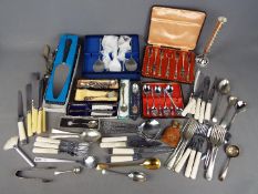 A quantity of plated and stainless flatware with cased examples and hallmarked silver handled