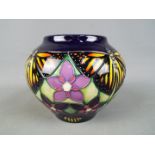 Moorcroft Pottery - a globular vase decorated with Monarch butterflies and flowers,