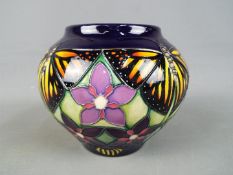 Moorcroft Pottery - a globular vase decorated with Monarch butterflies and flowers,