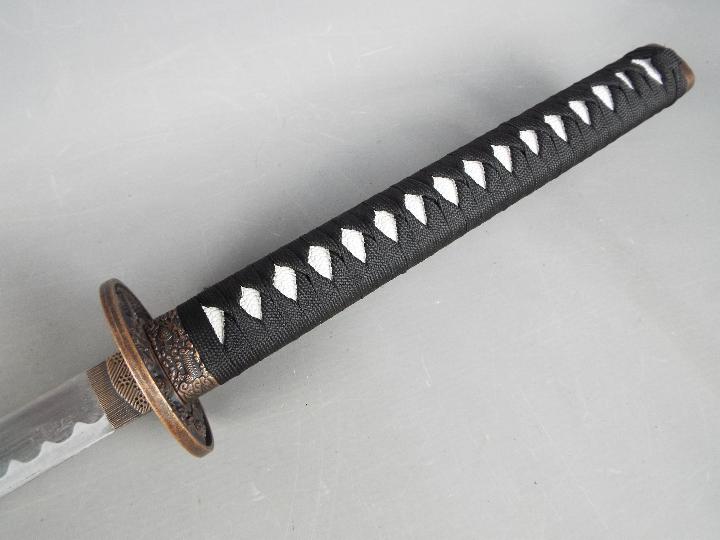 A reproduction Japanese sword with black lacquered, dragon decorated saya and dragon tsuba, - Image 2 of 4