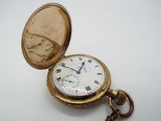 A yellow metal full hunter crown wind pocket watch,