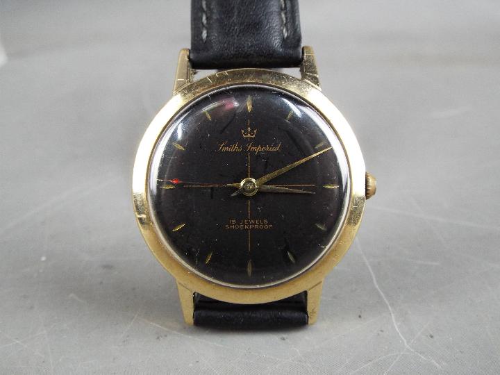 A gentleman's, yellow metal, Smiths Imperial wristwatch with black dial and 19 jewel movement, - Image 4 of 5