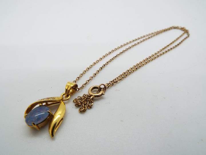 A yellow metal (unmarked) necklace with a 9ct gold pendant with stone set centre, - Image 4 of 4