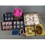 A quantity of boxed crystal glassware and an 18 piece Gainsborough tea set (boxed).