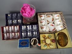 A quantity of boxed crystal glassware and an 18 piece Gainsborough tea set (boxed).