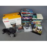 A quantity of DVD's, Playstation games, microphone, Kodak Easyshare printer dock and camera.