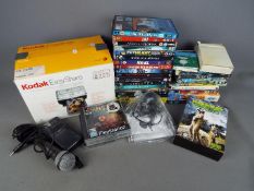 A quantity of DVD's, Playstation games, microphone, Kodak Easyshare printer dock and camera.