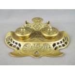 An early 20th century German brass inkwell / desk stand with pierced and floral decoration,