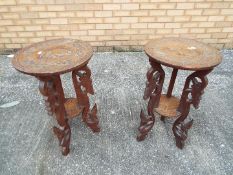 Two carved lamp tables or plant stands, each approximately 64 cm x 38 cm.