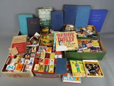 A collection of vintage books including Coast of Tragedy,