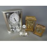 Four clocks to include carriage clock, anniversary clock and similar.