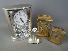 Four clocks to include carriage clock, anniversary clock and similar.