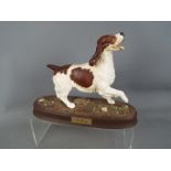 A Beswick pottery figure depicting a Spaniel mounted on an oval base,
