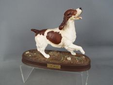 A Beswick pottery figure depicting a Spaniel mounted on an oval base,