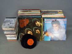 A collection of 12" vinyl records including The Beatles, ABBA, The Monkees, Kraftwerk and other,