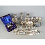 A quantity of plated ware to include cutlery, candelabra and similar.