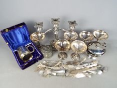 A quantity of plated ware to include cutlery, candelabra and similar.