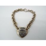 A belcher link charm bracelet with heart shaped charm stamped 'Please Return To Tiffany & Co.