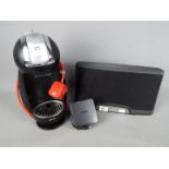 A Bose SoundDock Portable Digital Music System and a Krups Dolce Gusto coffee machine.