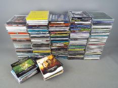 A box of CD's, varying genres.