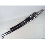 Two reproduction Japanese swords with black lacquered saya, longest approximately 109 cm.