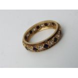 A lady's hallmarked 9 carat yellow gold eternity ring set with red and white stones, approx 2.