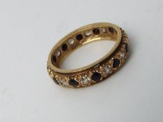 A lady's hallmarked 9 carat yellow gold eternity ring set with red and white stones, approx 2.