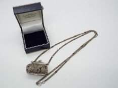 A miniature silver coin purse on silver chain, both stamped 925, purse approximately 3.5 cm (l).