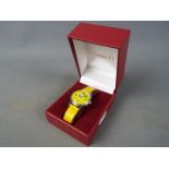 A Timex 'Snoopy Tennis' wristwatch with yellow dial and strap, case diameter approximately 3 cm.