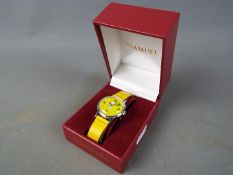 A Timex 'Snoopy Tennis' wristwatch with yellow dial and strap, case diameter approximately 3 cm.